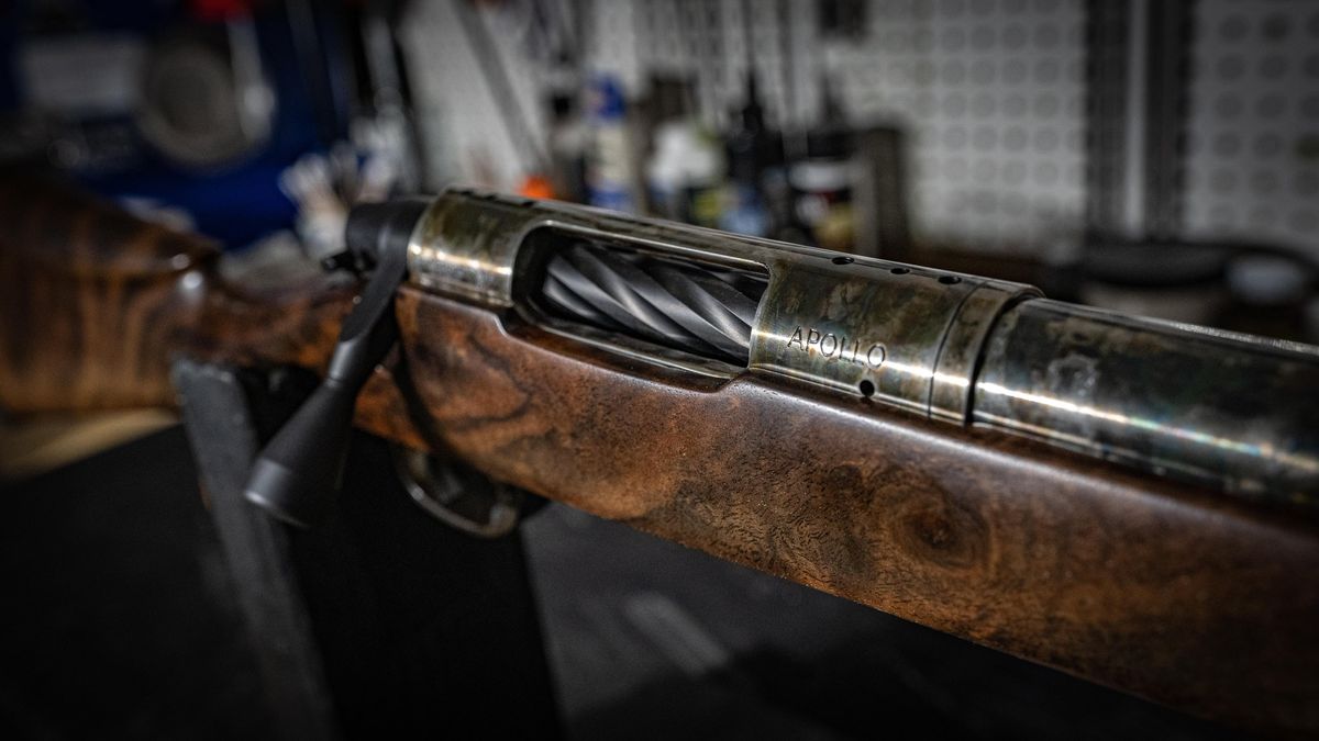 Close-up of a custom rifle's walnut stock and bolt