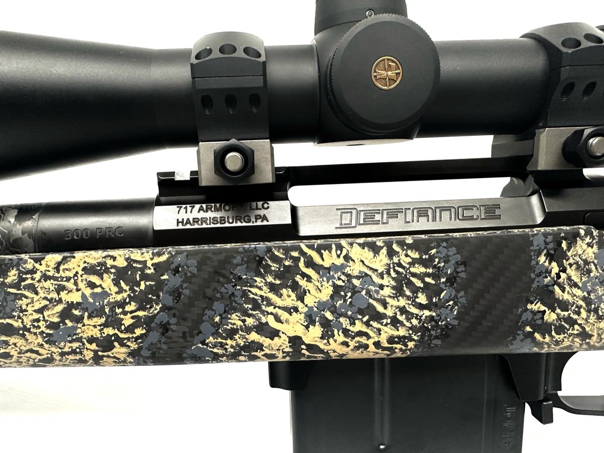 Close-up of a custom rifle's action and scope rings